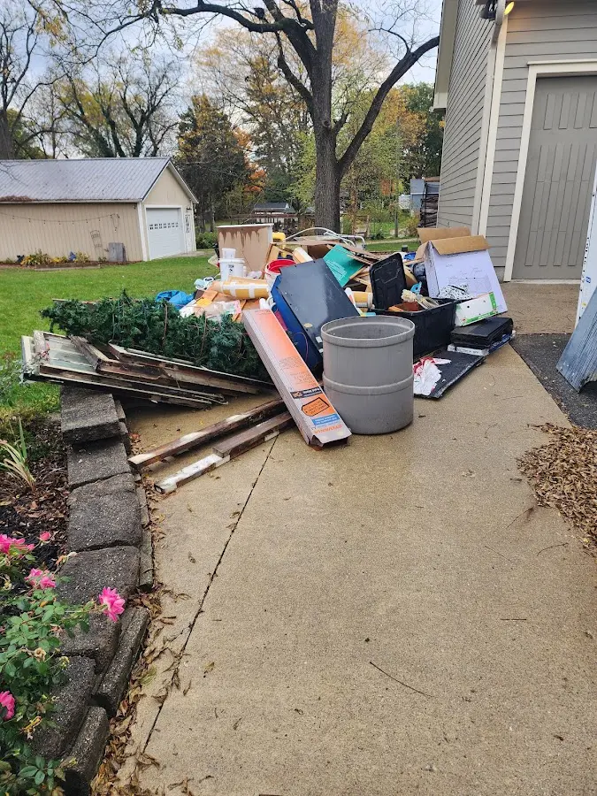 Dumpster being loaded with debris for Roofing Dumpster Rental in Centerville